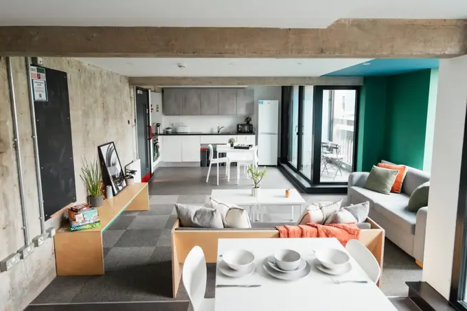 Shot of social area in Beton House, showing dining area, living room and kitchen. 